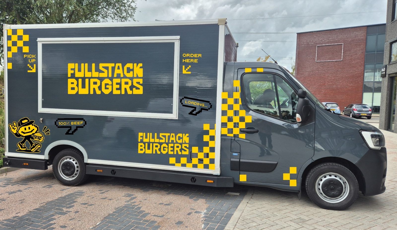 The original Fullstack Burgers food truck with yellow lettering and pixel patterns, shown in full.